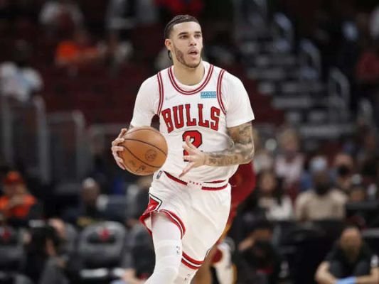Picture of Lonzo Ball wearing a Bulls Jersey and Holding a basketball.